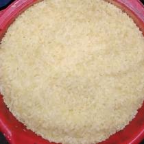 Volunteer A J Salim: Measuring rice carefully.
